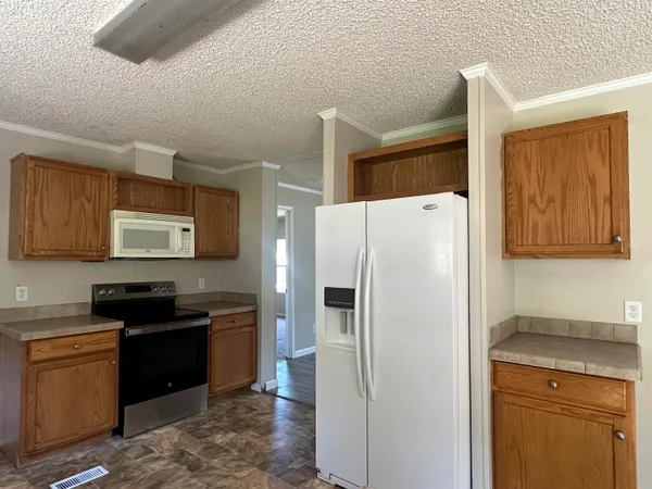 a white refrigerator freezer sitting in a kitchen