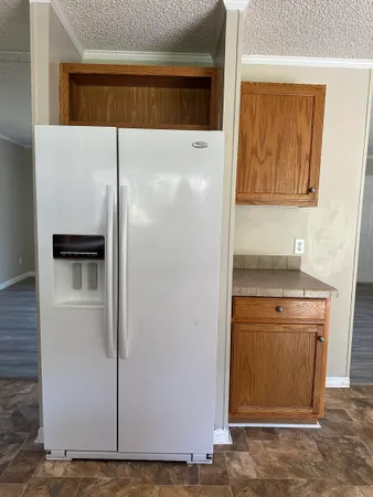 a kitchen with a refrigerator and a stove