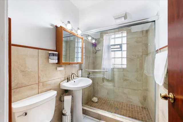 a bathroom with a sink toilet and shower