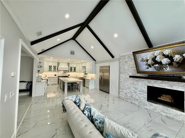 a view of a bedroom with wooden floor and window