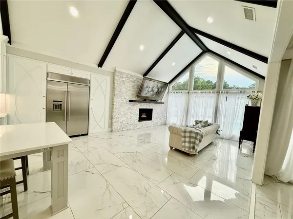 a bedroom with a bed a flat screen tv and dresser