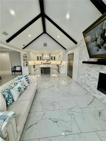 a living room with a fireplace and a book shelf