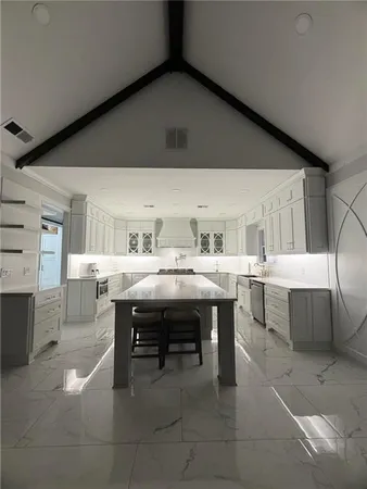 a view of a dining room with furniture and a chandelier