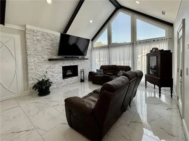 a bedroom with a bed a flat screen tv and dresser