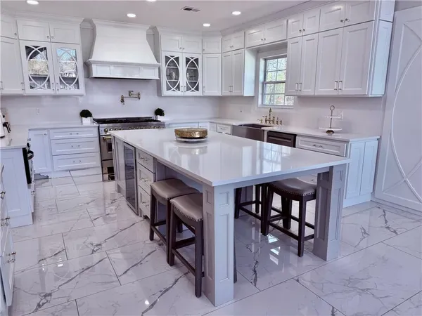 a spacious bathroom with a granite countertop sink a mirror and a