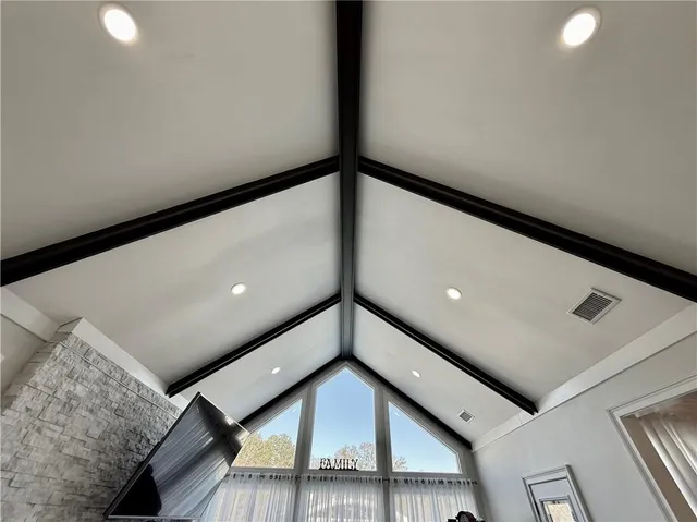 a living room with a fireplace and a book shelf