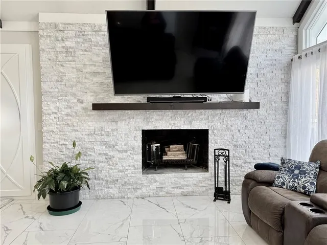 a view of a dining room with furniture and a chandelier