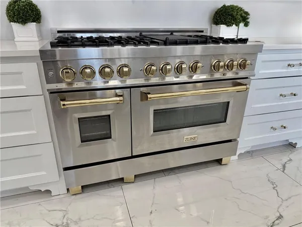 a bedroom with a bed a dresser and wooden floor