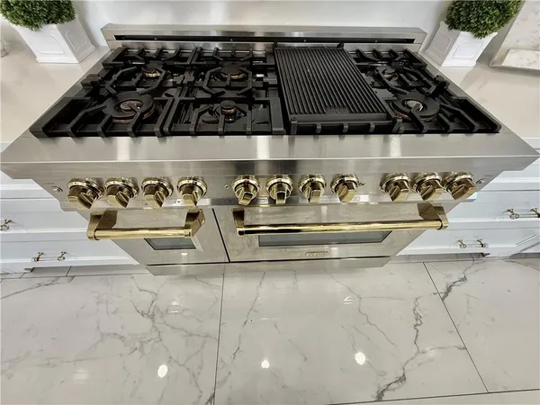 a bedroom with bed and a flat tv screen on dresser