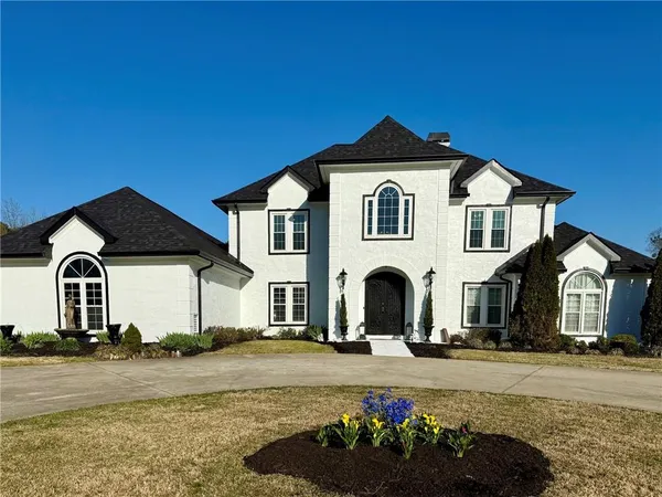 a front view of a house with yard and garage