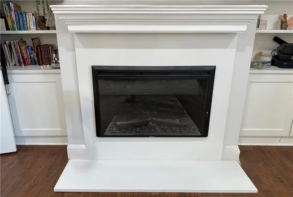 a bedroom with a bed a dresser and potted plants