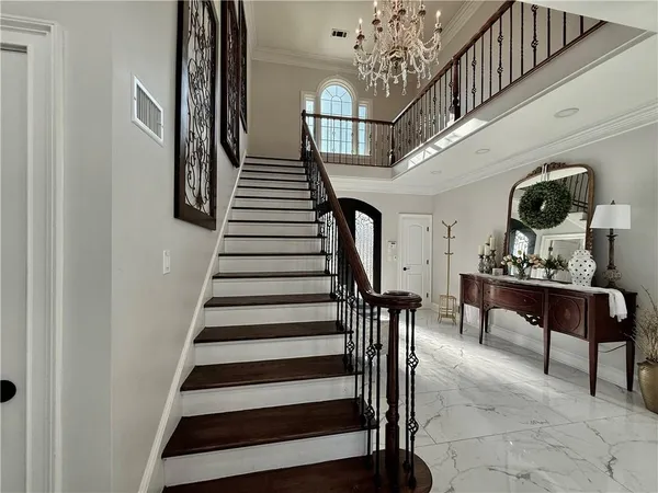 a view of an empty room with a ceiling fan and wooden floor