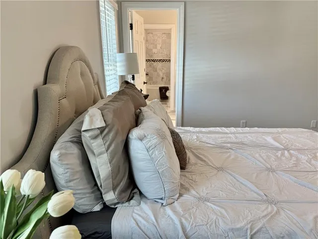 a view of an empty room with a ceiling fan and wooden floor