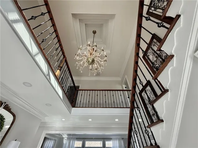 a view of a dining room with furniture and a chandelier