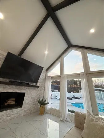 a view of a refrigerator in kitchen and an empty room