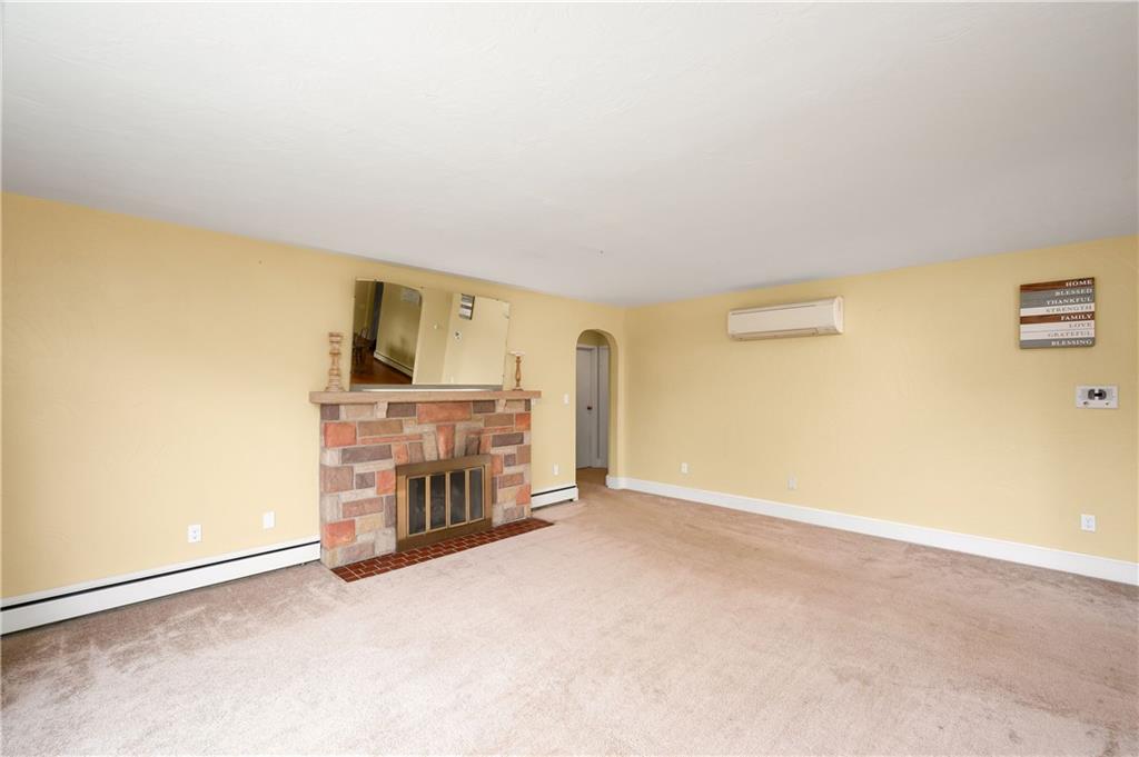 120 West Sunbury Road Butler, PA 16001 - Photo 16 of 46 an empty room with a fireplace and a projector