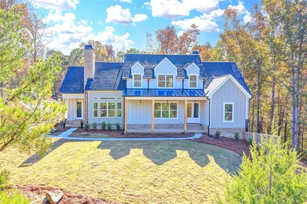 a front view of house with swimming pool and porch