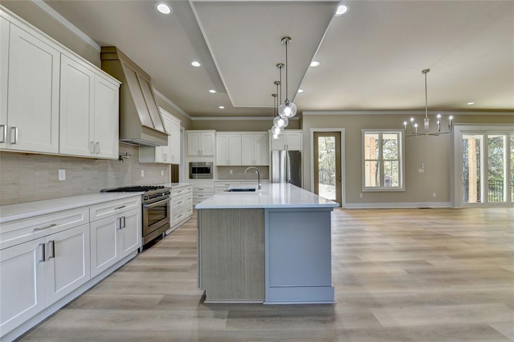 2881 Traditions Way Jefferson, GA 30549 - Photo 11 of 59 a large kitchen with kitchen island a sink stainless steel appliances and cabinets