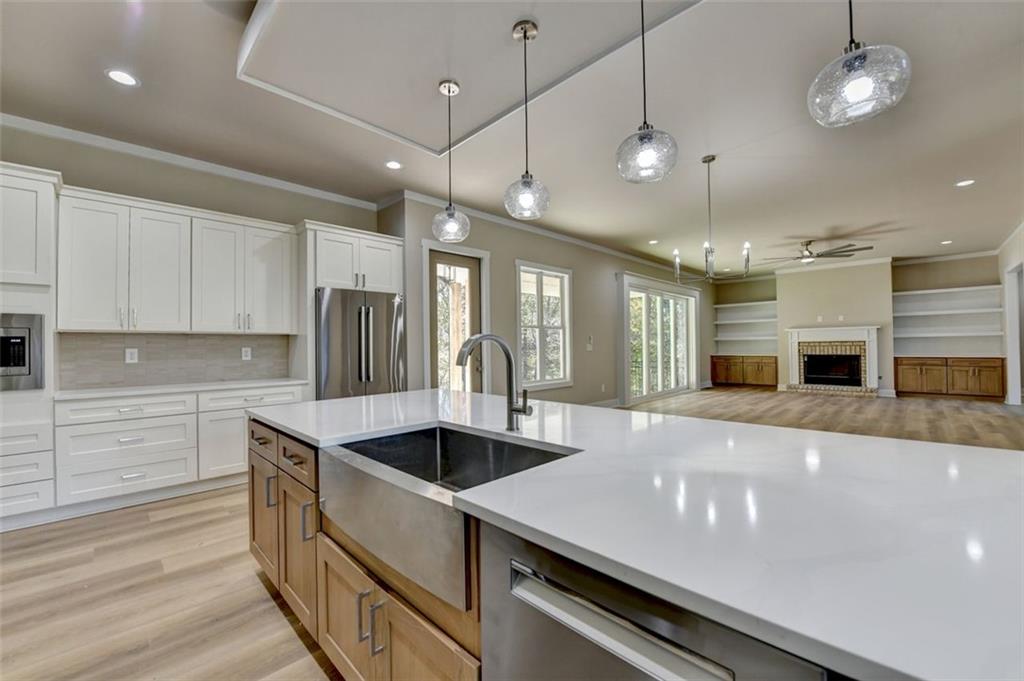 2881 Traditions Way Jefferson, GA 30549 - Photo 12 of 59 a large kitchen with stainless steel appliances a large counter top a stove and a wooden floors