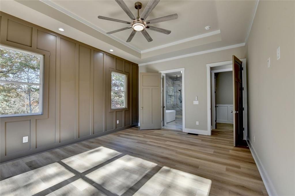 2881 Traditions Way Jefferson, GA 30549 - Photo 16 of 59 a view of a hallway with a chandelier fan and windows