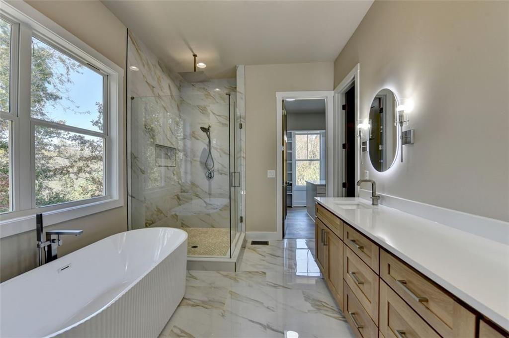 2881 Traditions Way Jefferson, GA 30549 - Photo 17 of 59 a spacious bathroom with a granite countertop tub double sink and a mirror