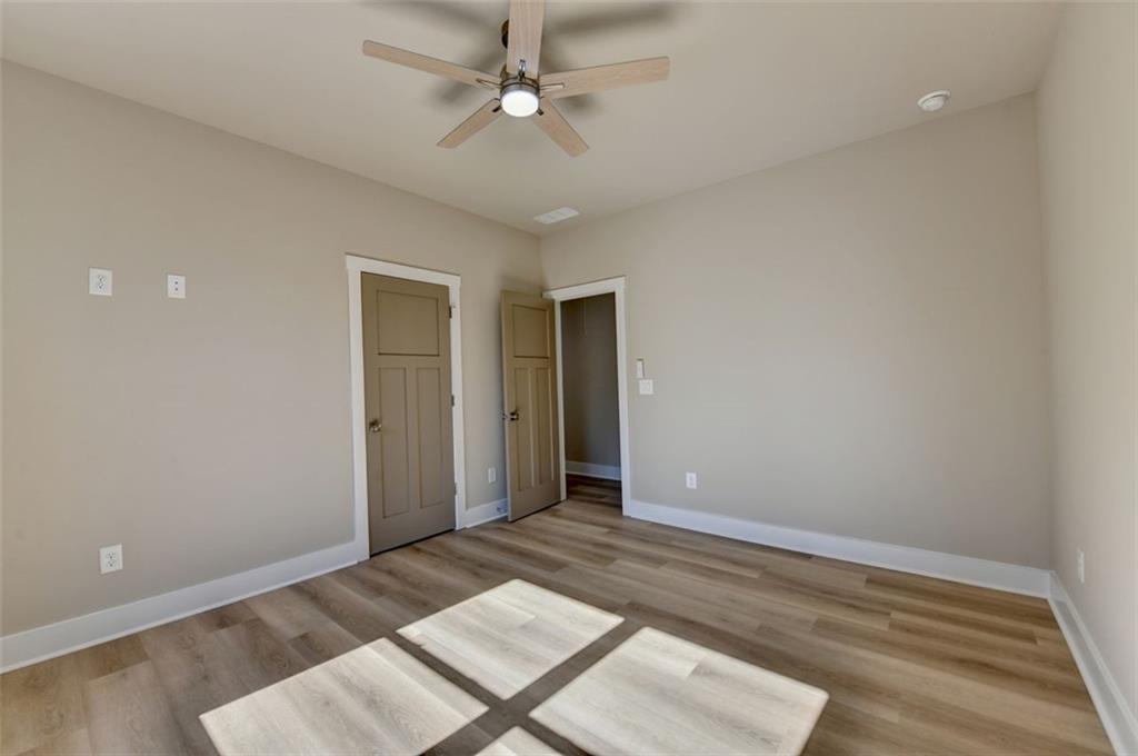2881 Traditions Way Jefferson, GA 30549 - Photo 26 of 59 an empty room with wooden floor and ceiling fan