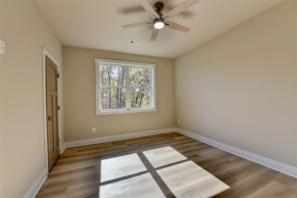 2881 Traditions Way Jefferson, GA 30549 - Photo 28 of 59 wooden floor in an empty room with a window