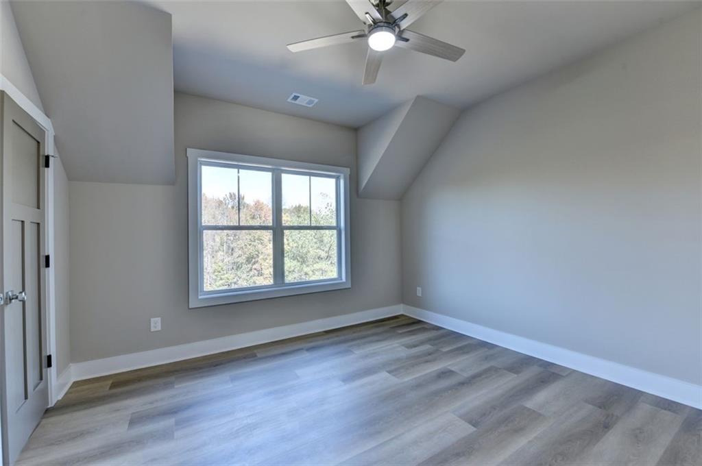2881 Traditions Way Jefferson, GA 30549 - Photo 31 of 59 an empty room with wooden floor and windows