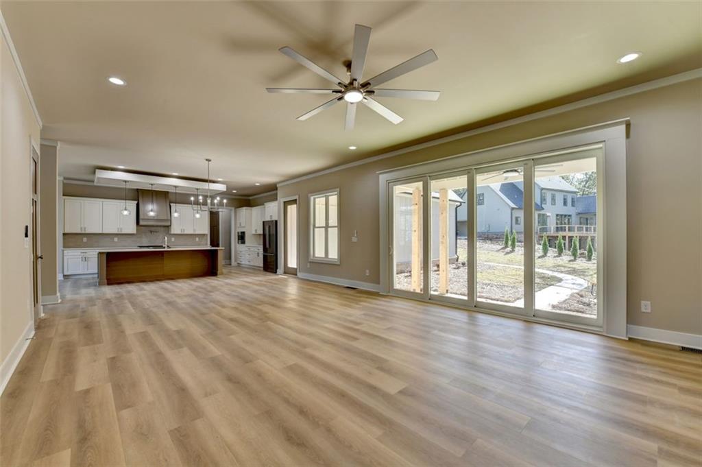 2881 Traditions Way Jefferson, GA 30549 - Photo 6 of 59 a view of an empty room with a window and wooden floor