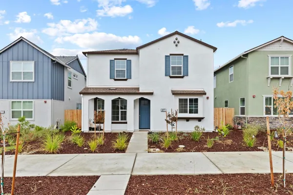 a front view of a house with a yard