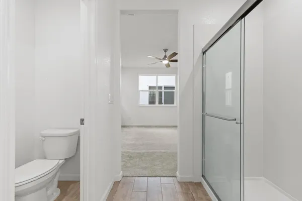 a bathroom with a toilet and a shower