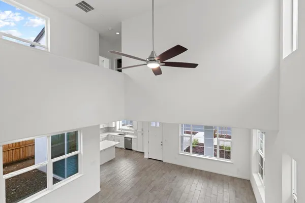 a living room with wooden floor and white walls