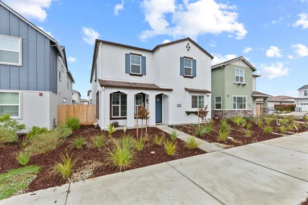 a front view of a house with garden