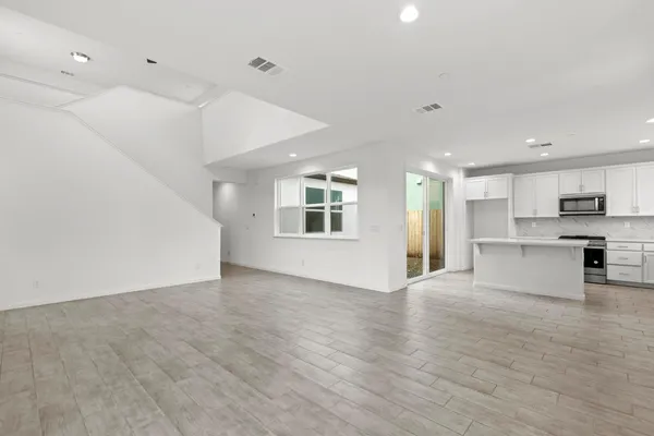 a view of kitchen with stove and cabinets