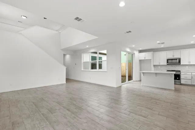 a view of kitchen with stove and cabinets