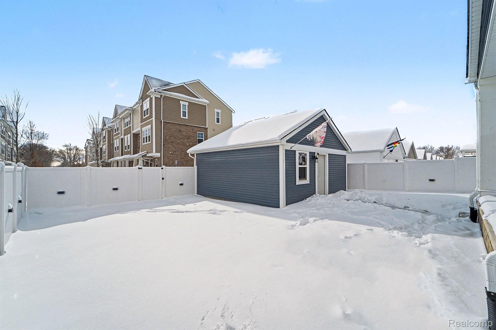 2471 Massoit Road Royal Oak, MI 48073 - Photo 41 of 49 Snowy yard with a fenced backyard and an outbuilding