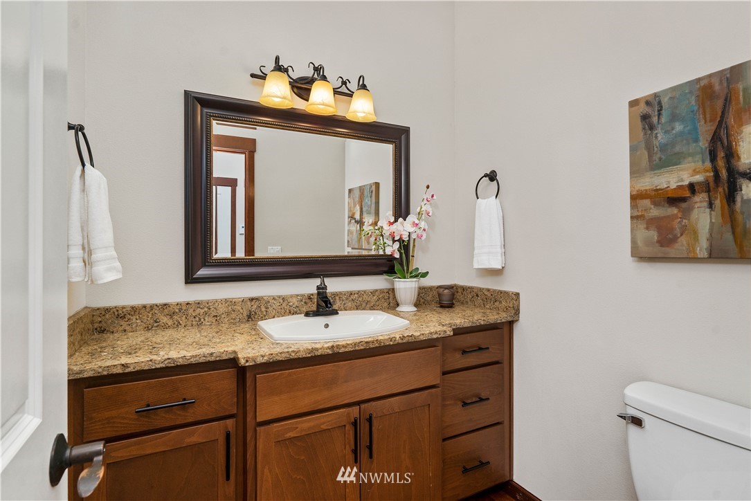 1317 North 40th Street Renton, WA 98056 - Photo 12 of 40 a bathroom with a granite countertop sink vanity mirror and toilet