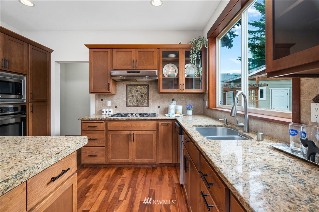 1317 North 40th Street Renton, WA 98056 - Photo 15 of 40 a kitchen with stainless steel appliances granite countertop a sink stove and refrigerator