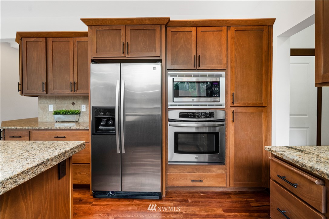 1317 North 40th Street Renton, WA 98056 - Photo 16 of 40 a kitchen with granite countertop a refrigerator and a stove