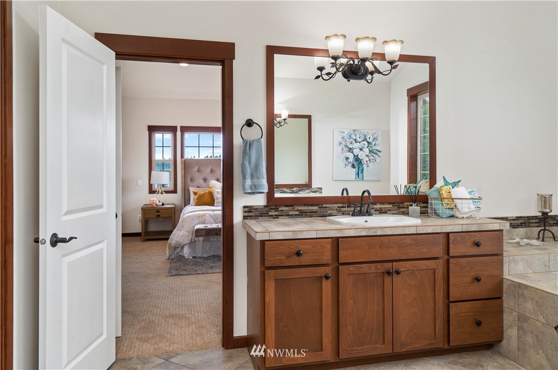 1317 North 40th Street Renton, WA 98056 - Photo 22 of 40 a en suite bathroom with a granite countertop sink and a mirror
