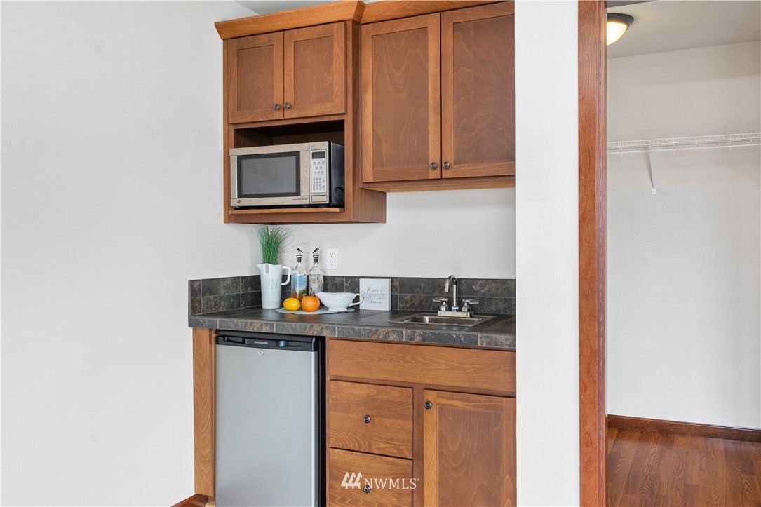 1317 North 40th Street Renton, WA 98056 - Photo 33 of 40 a kitchen with stainless steel appliances granite countertop a sink and cabinets