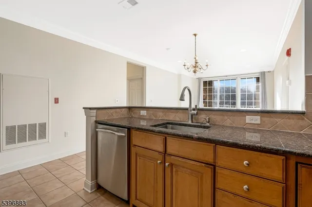 a kitchen with granite countertop a sink and a window