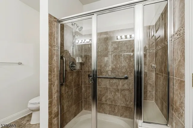 a bathroom with a glass shower door
