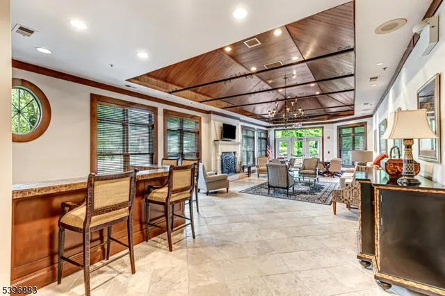a living room with furniture a fireplace and a table