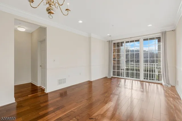 a view of wooden floor and windows in a room