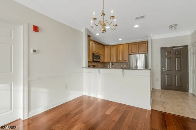 a view of a kitchen with a sink cabinet and a refrigerator