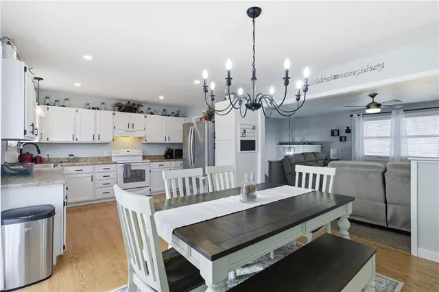 a large kitchen with a table and chairs