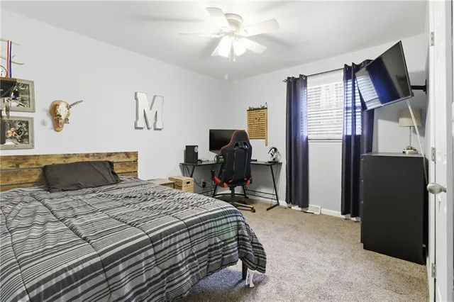 a bedroom that has a bed and a chandelier
