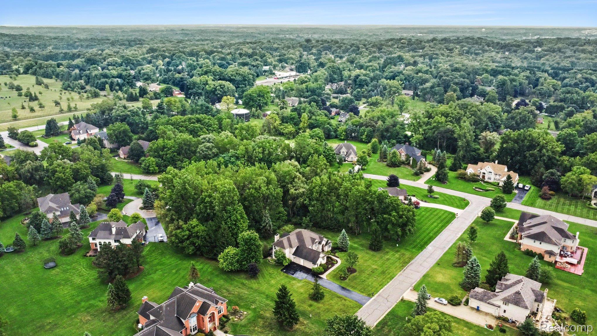 4875 Green Meadow Lane Rochester, MI 48306 - Photo 56 of 60 Expansive property featuring manicured lawns, mature trees, and paved streets