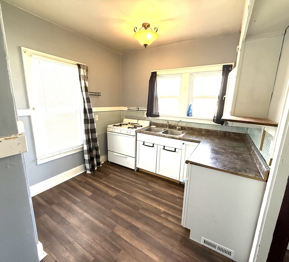 302 West Division Street Amboy, IL 61310 - Photo 13 of 23 a kitchen with a stove a sink and a refrigerator